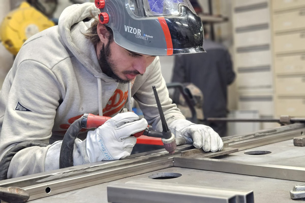 Un soudeur ferronnier en action dans l'atelier Yoann Métal